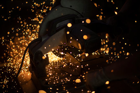 cutting metal with sparks. Lights in dark. tool operation. Large saw cuts steel.の写真素材