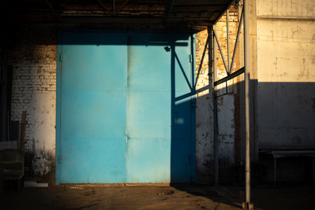 Gate to large garage. Blue gate to warehouse. industrial zone. Entrance to building.の写真素材