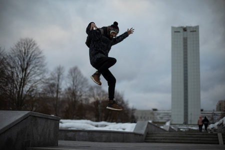 Guy jumps in front of building. man in flight. fun walk.の写真素材