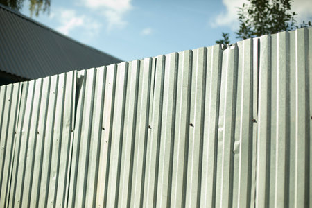 Steel fence detail. Fence made of metal profile. Durable material to protect against prying eyes. Private territory.の写真素材
