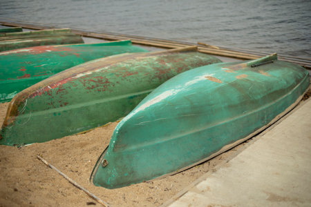 Old boats are overturned on shore. boat station. Boats are drying up. water transport.の写真素材
