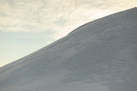Snowy slope. Snowdrifts in winter. slide of snow. weathered surface.の写真素材
