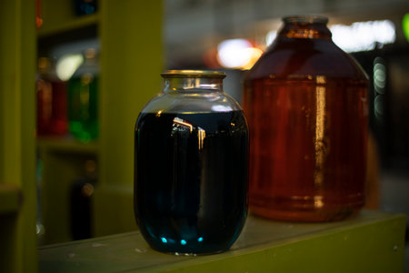 Cans on shelf with colored water. interior details. glass containers. big cans.の写真素材