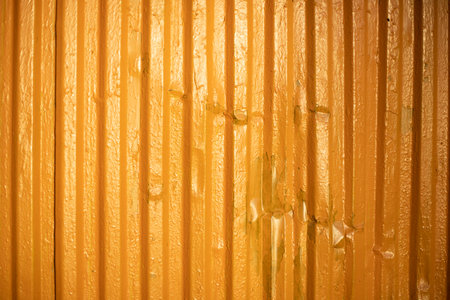 yellow texture. painted metal. Surface is ribbed. Thick coat of paint.の写真素材