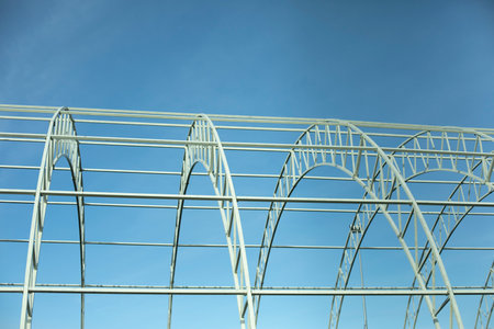 Basis for warehouse. metal beams. Details of construction of sports complex. Steel details against blue sky.の写真素材