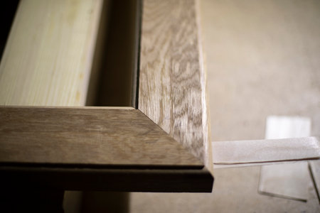 wooden frame detail. Angle of board. Treated surface of frame for mirror. Furniture made of wood. joinery.の写真素材