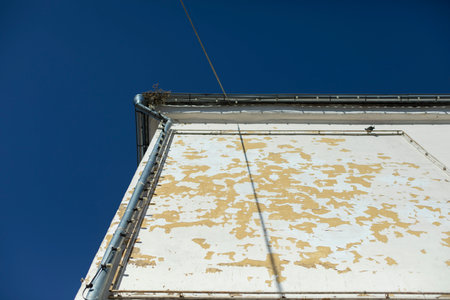 old wall of house. Empty advertising space on building. View of drainpipe on roof.の写真素材