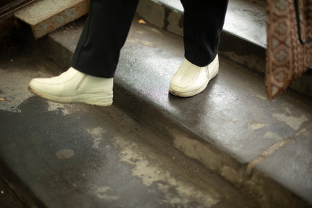 Feet go up steps. white shoes. Move up stairs. man in town.の写真素材