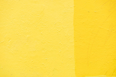 Yellow wall texture. Background yellow paint on wall. bright color. painted surface.の写真素材