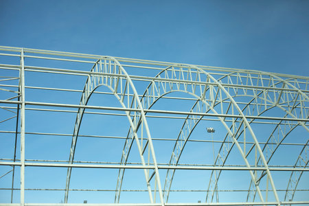 Basis for warehouse. metal beams. Details of construction of sports complex. Steel details against blue sky.の写真素材