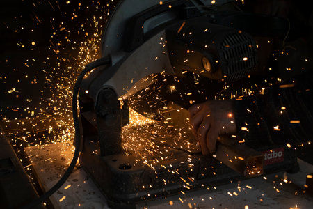 Sparks in dark. cutting steel. industrial equipment. Lights fly in different directions.の写真素材