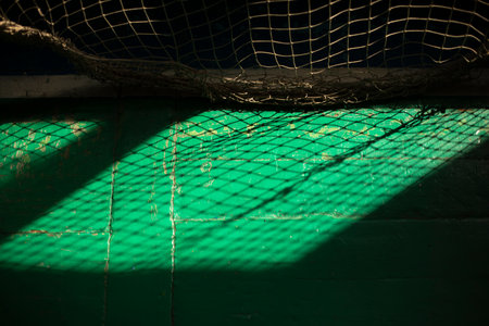 Light through grid. Light in gym. Shadow on floor. Rays from window.の写真素材