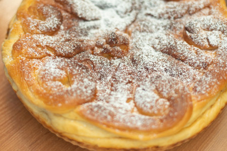Sweet apple pie. Delicious pastries. Sweet powder on cake. Rustic pastries.の写真素材