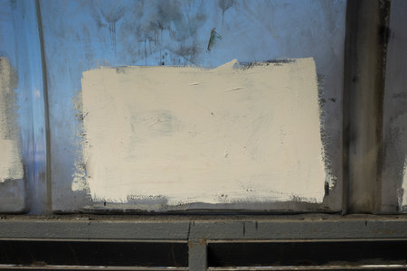 White paint on wall. Painted over inscription. Anti-vandal measures. white spot.の写真素材