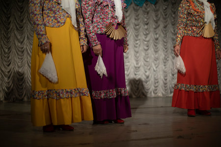 folk costumes. Women perform on stage. Folklore ensemble. Beautiful dresses of Slavic style.の写真素材