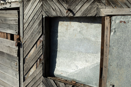 An old building in the village. Wooden building in an old house. Assembled from planks many years ago. Details of the construction.の写真素材