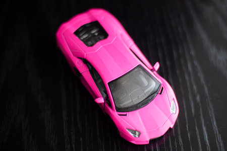Sport car. Toy car model. High-speed transport. Exclusive racing car replica. Action figure macro. Side view Dark background.の写真素材