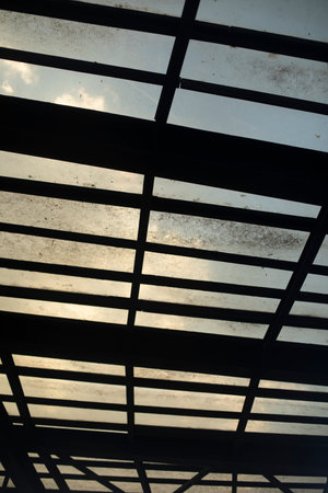 Glass roof. Dirt on roof. Interior details. Glass and fittings.の写真素材