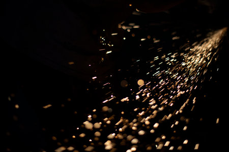 Grinding of steel. Sparks from metal. hot particles. small lights. Work on metal profile.の写真素材