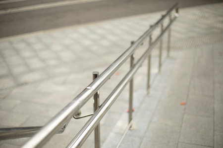 A handrail for a pedestrian. Steel handrail by the road. Pedestrian area. Details of urban architecture.の写真素材