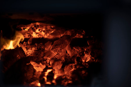 Burning of firewood in hearth. Flames of pyre. Texture of fire inside furnace. Combustion process.の写真素材