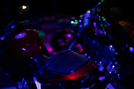 Motorcycle in dark. Transport in blue light. Bike at disco. Light on machine body.の写真素材