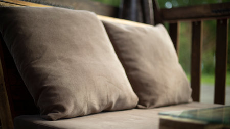 Upholstered armchairs in restaurant. Craft furniture. Pillows for relaxation. Interior details.の写真素材