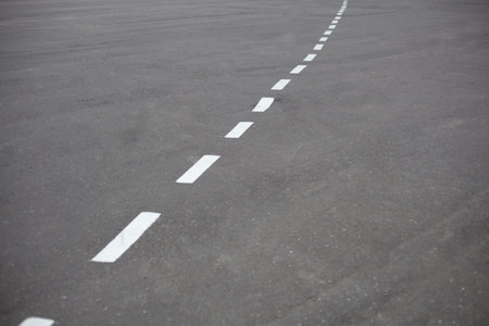 Bike path. Markings on the road. Broken white line on asphalt. Led markings.の写真素材