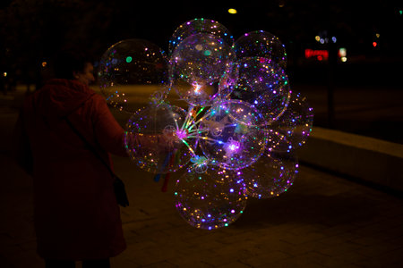 Balloons with lights. Garlands in dark. Glowing light bulbs inside empty balls. Fun item.の写真素材