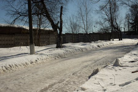 Road in the snow. Road in winter in the countryside. Street on a cold day. Icing of the track.の写真素材