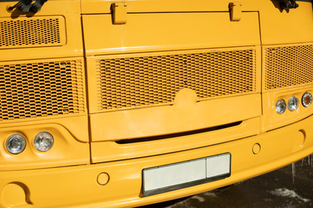 Yellow school bus. Details of school transport. Car headlights. Old public transport.の写真素材