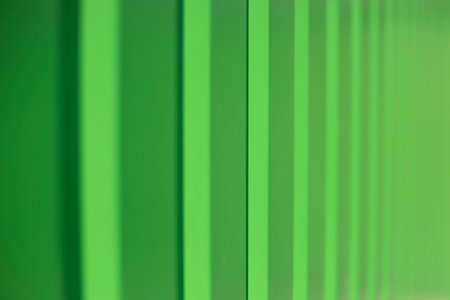 Green fence. Fence in detail. Ribbed steel. Bright background wall surface.の写真素材