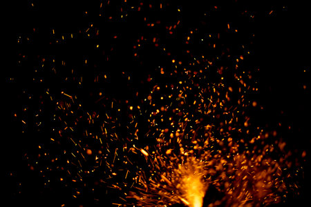 The texture of the fire. Sparks in the dark. Flames on a black background. Small sparks.の写真素材