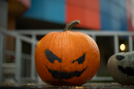 Pumpkin with a terrible face. Black paint on pumpkin. Harvest Day. Idle Spirits.の写真素材