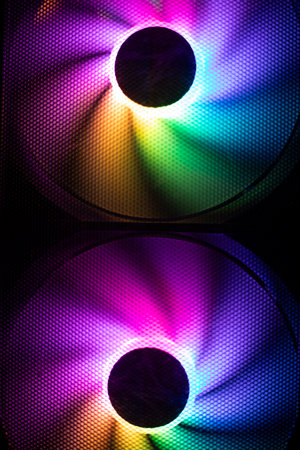 Colored fan in the computer. LED lighting in the system unit. Bright light in the fan. Computer parts.の写真素材