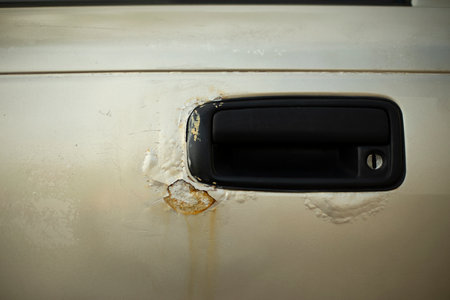 Rusty car door. Transportation Door Handle. Transport details. Damaged Steel.の写真素材