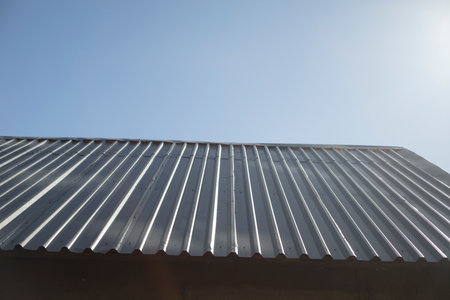 Steel roof. Roof of building. Steel profile. Roof is made of metal.の写真素材