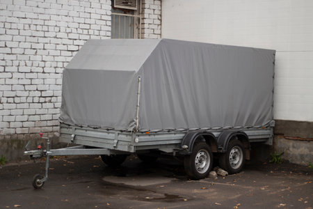 Trailer for the car. Gray awning on a trailer. Vehicle parking. Transportation of small loads.の写真素材