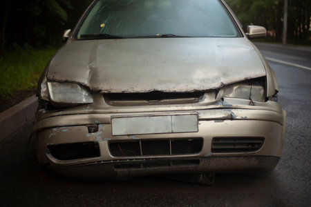 Wrecked car on the street. Old car. Dented hood. Transport after the accident.の写真素材