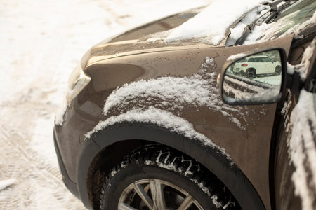The machine in winter in detail. Snow on transport. Car parts. Frozen car.の写真素材