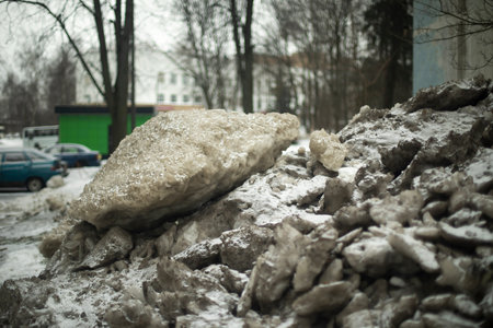 Blocks of ice outside. Collected snow in yard. Cleaning area. Lot of chunks of ice.