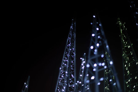 Garlands on street at night. Decoration of the city. Structure is decorated with garlands; . Lots of...