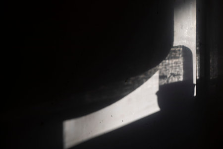 Shadow on the wall. Light on a white wall. Morning in the room. Soft glow.