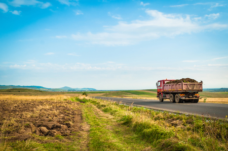 Truck transporting soil on a field.の写真素材