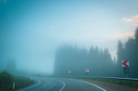 Left turn on misty roadの写真素材