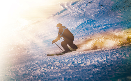 Skier silhouette sunset ride in the mountainsの写真素材