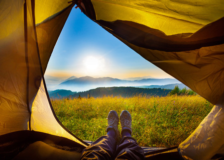 Watching the sunrise from the tentの写真素材