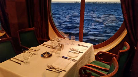 Dining table on a cruise ship looking out the windowの写真素材