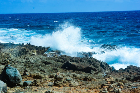 Waves Crashing on the Volcanic Coast in the Caribbeanの写真素材