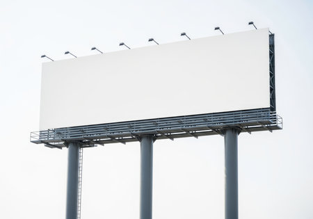 A large blank advertising billboard with a clean white surface and sturdy metal structure, isolated. Ideal for marketing campaigns, announcements, or creative designs.の素材
